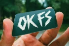 OK FS KOUINIA DUSTY sticker held in hand